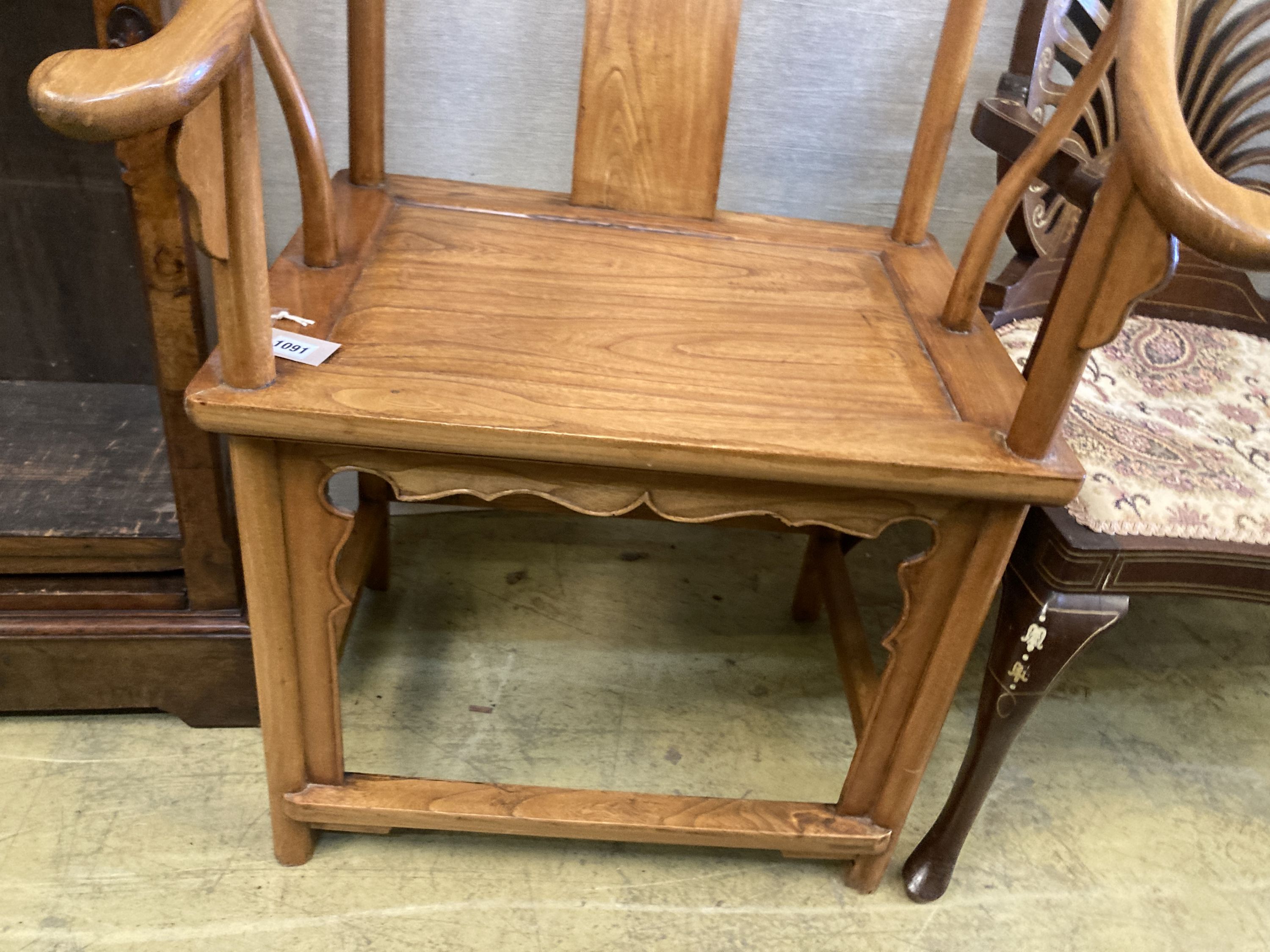 A Chinese elm armchair, with round back and pierced carved splat, width 67cm, depth 50cm, height 100cm